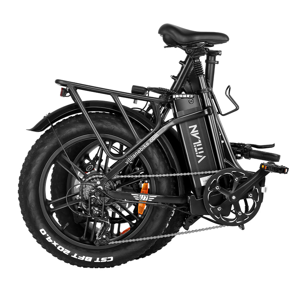Folded black electric bike with thick tires and rear cargo rack on a white background