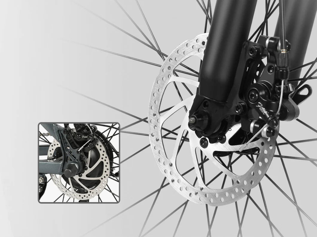 Close-up of a bicycle front wheel with disc brakes, showing detailed view of the brake rotor and caliper. An inset highlights a rear wheel with a similar disc brake mechanism. Both wheels have metal spokes.