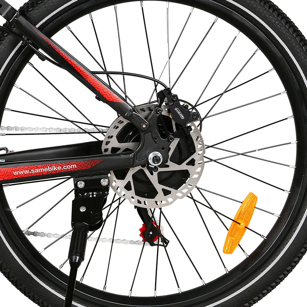 Close-up of the Samebike XD26-II Electric Bike’s rear wheel shows the disc brake rotor, black frame, spokes, rear derailleur, chain, and orange reflector—highlighting its dual suspension system for a smoother ride.